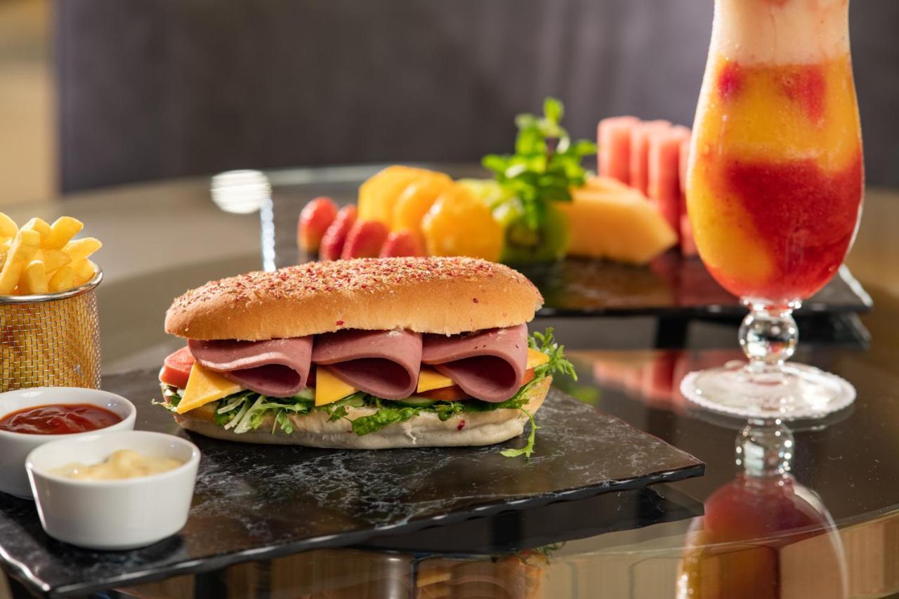 Millennium Makkah Al Naseem Mecca Exterior photo A sandwich with ham and cheese